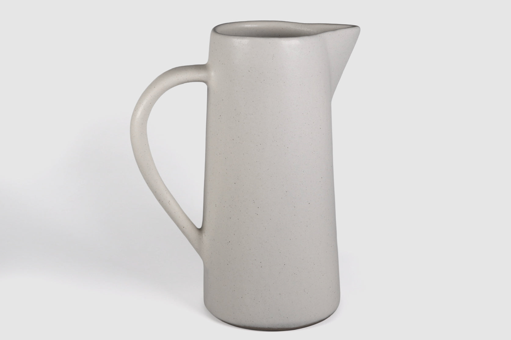 Tall Rojizo ceramic pitcher with tapered body, pouring lip and pulled handle