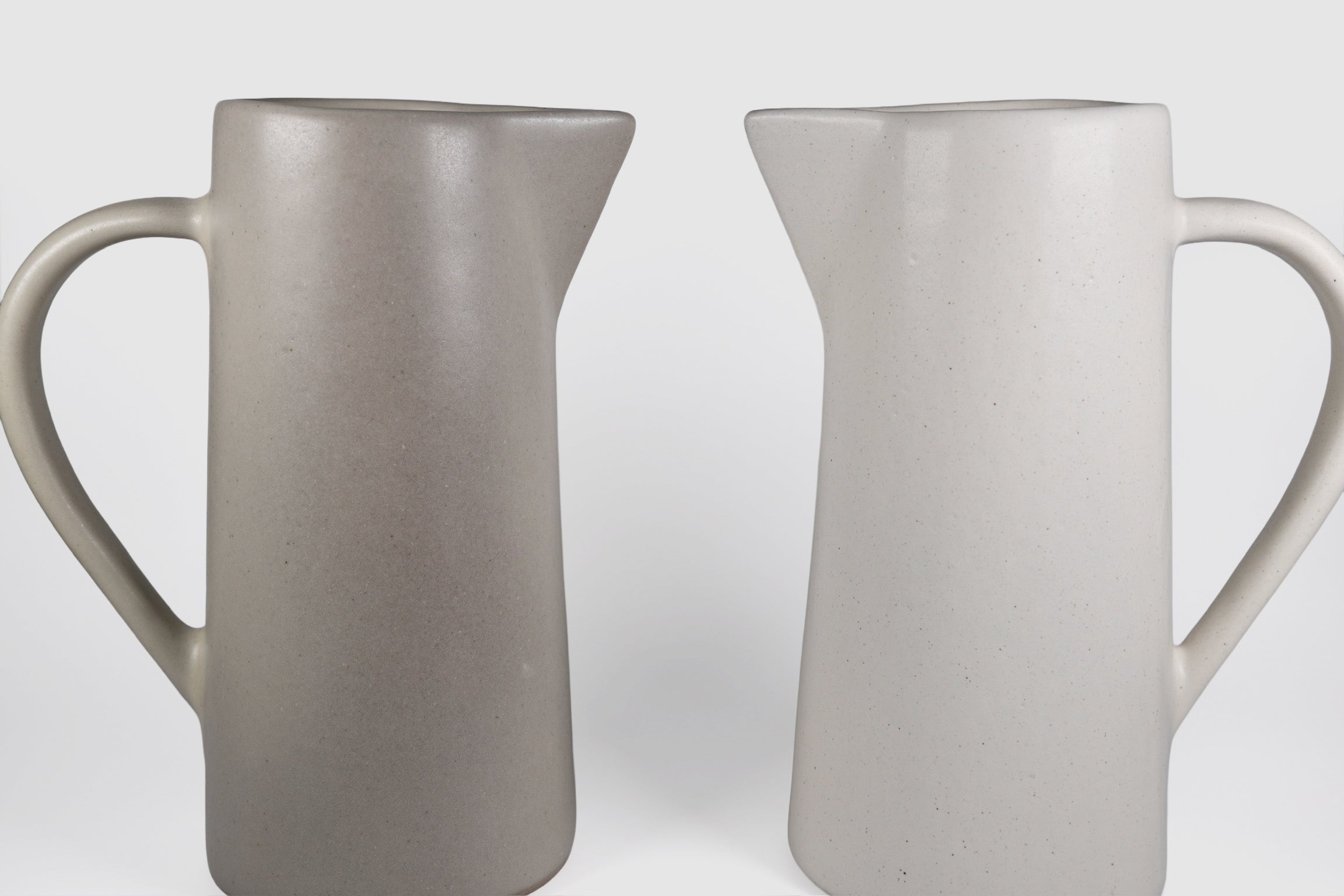Tall Rojizo ceramic pitcher with tapered body, pouring lip and pulled handle