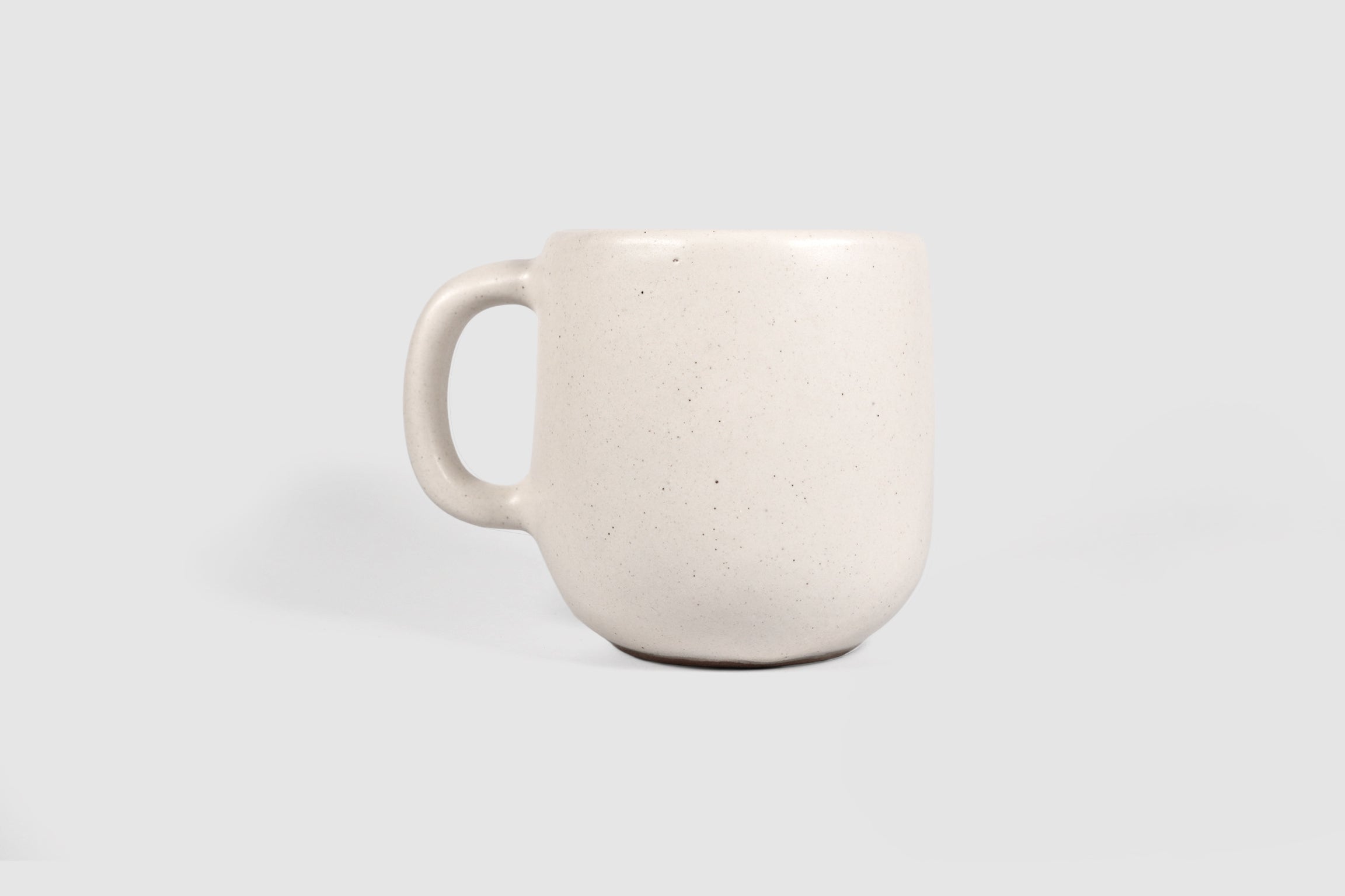 Cappuccino mug with swelling body and pulled handle in Chocolate glaze