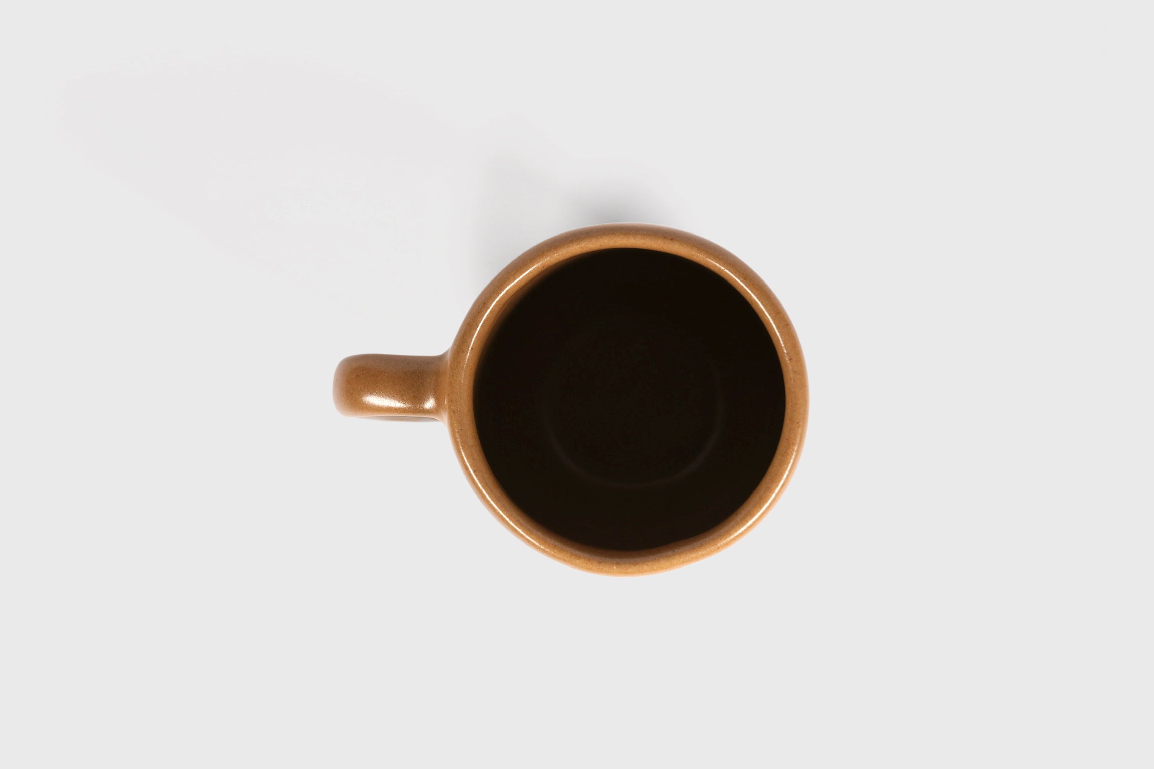 Cappuccino mug with swelling body and pulled handle in Chocolate glaze
