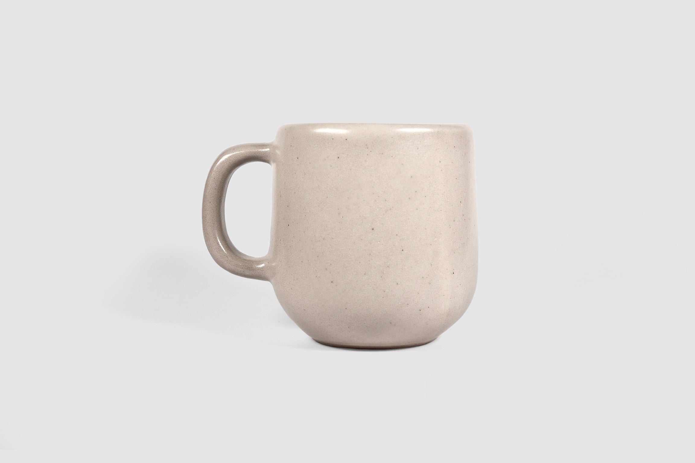 Cappuccino mug with swelling body and pulled handle in Chocolate glaze