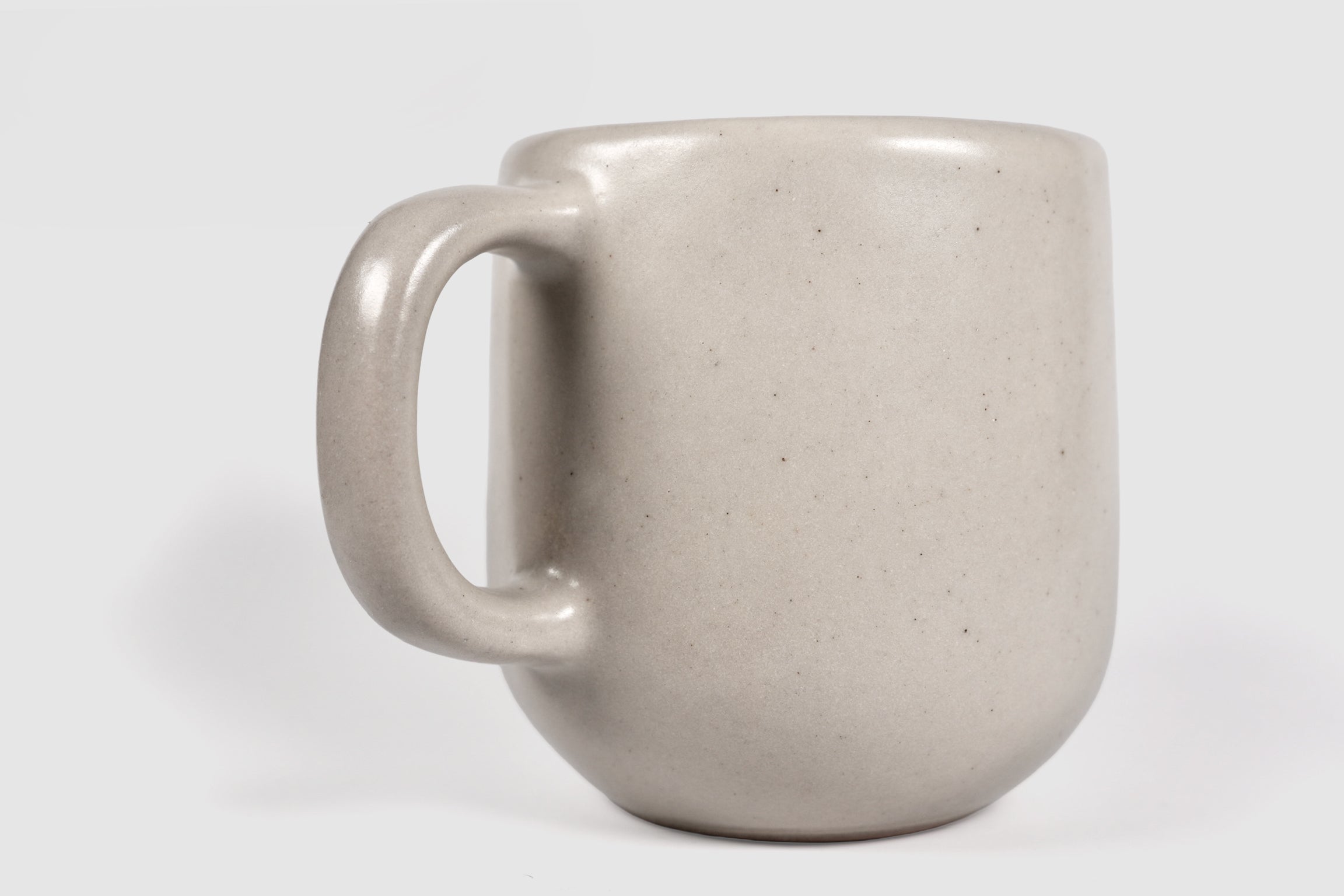 Cappuccino mug with swelling body and pulled handle in Chocolate glaze