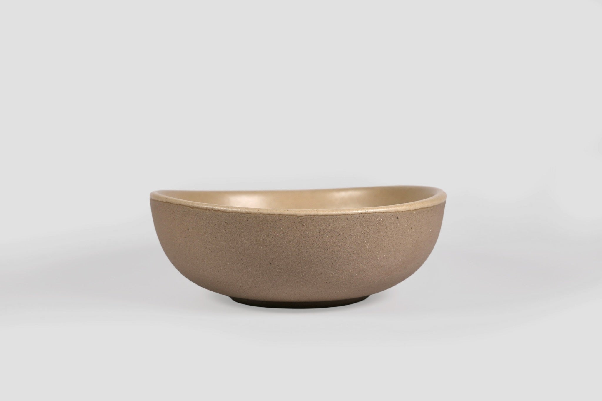 Bowl Sanka by Humo 1810 – black semi-matte stoneware, unglazed exterior, soft triangular form, 6.25 inch