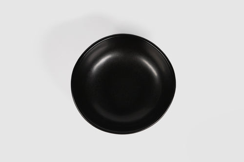 Bowl Sanka by Humo 1810 – black semi-matte stoneware, unglazed exterior, soft triangular form, 6.25 inch