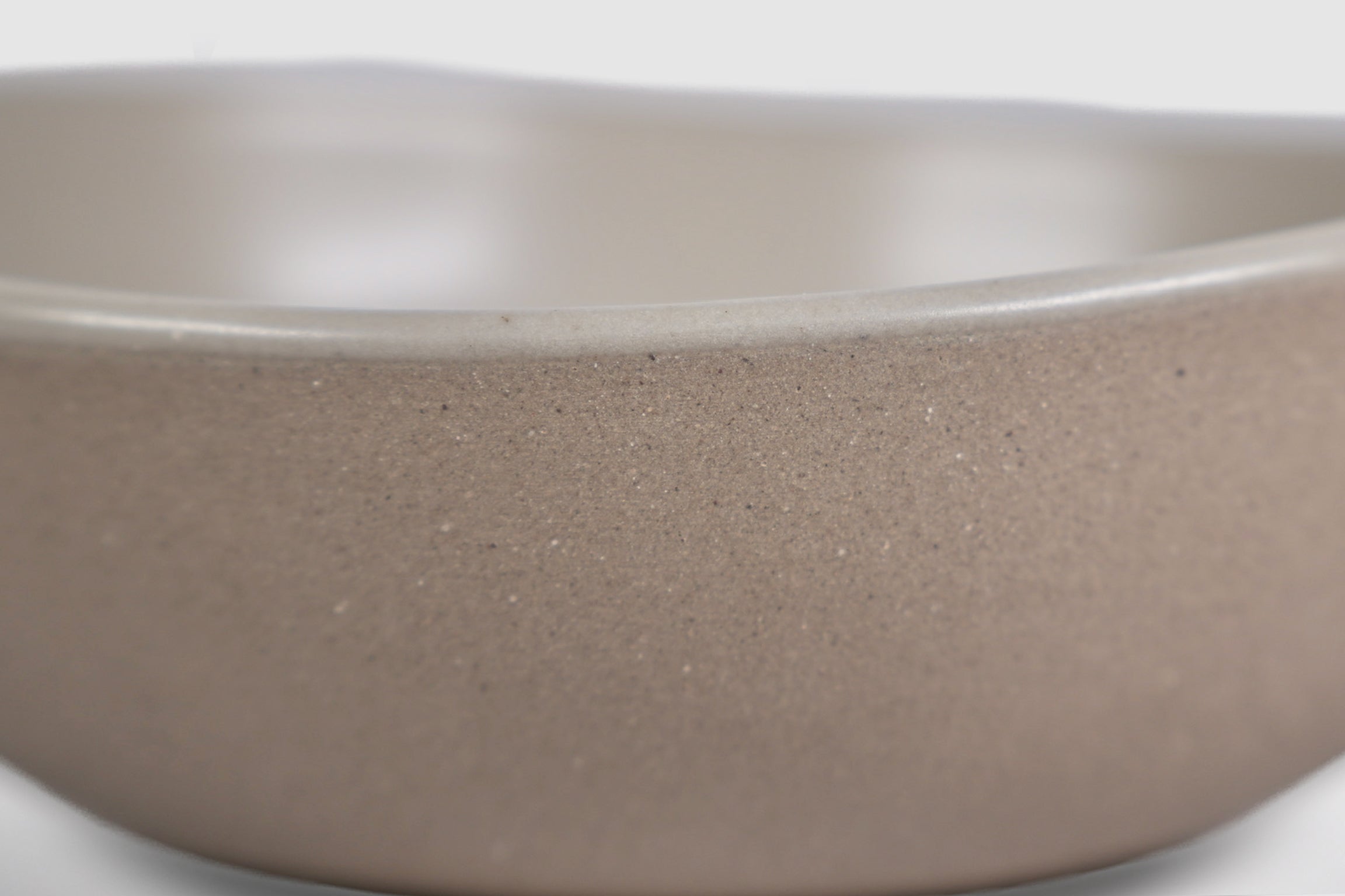Bowl Sanka by Humo 1810 – black semi-matte stoneware, unglazed exterior, soft triangular form, 6.25 inch