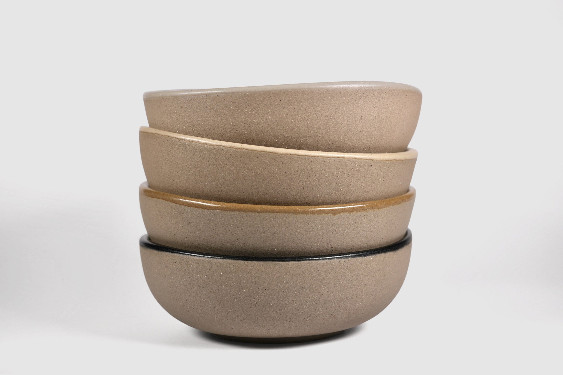 Bowl Sanka by Humo 1810 – black semi-matte stoneware, unglazed exterior, soft triangular form, 6.25 inch