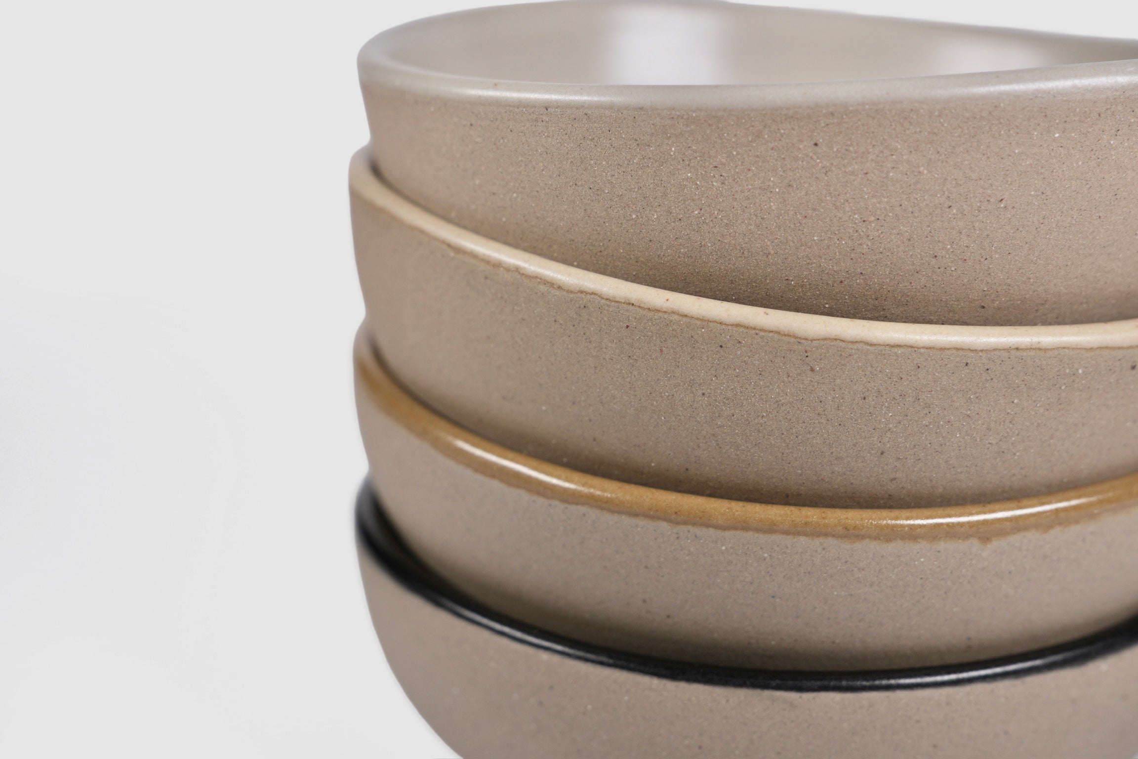Bowl Sanka by Humo 1810 – black semi-matte stoneware, unglazed exterior, soft triangular form, 6.25 inch