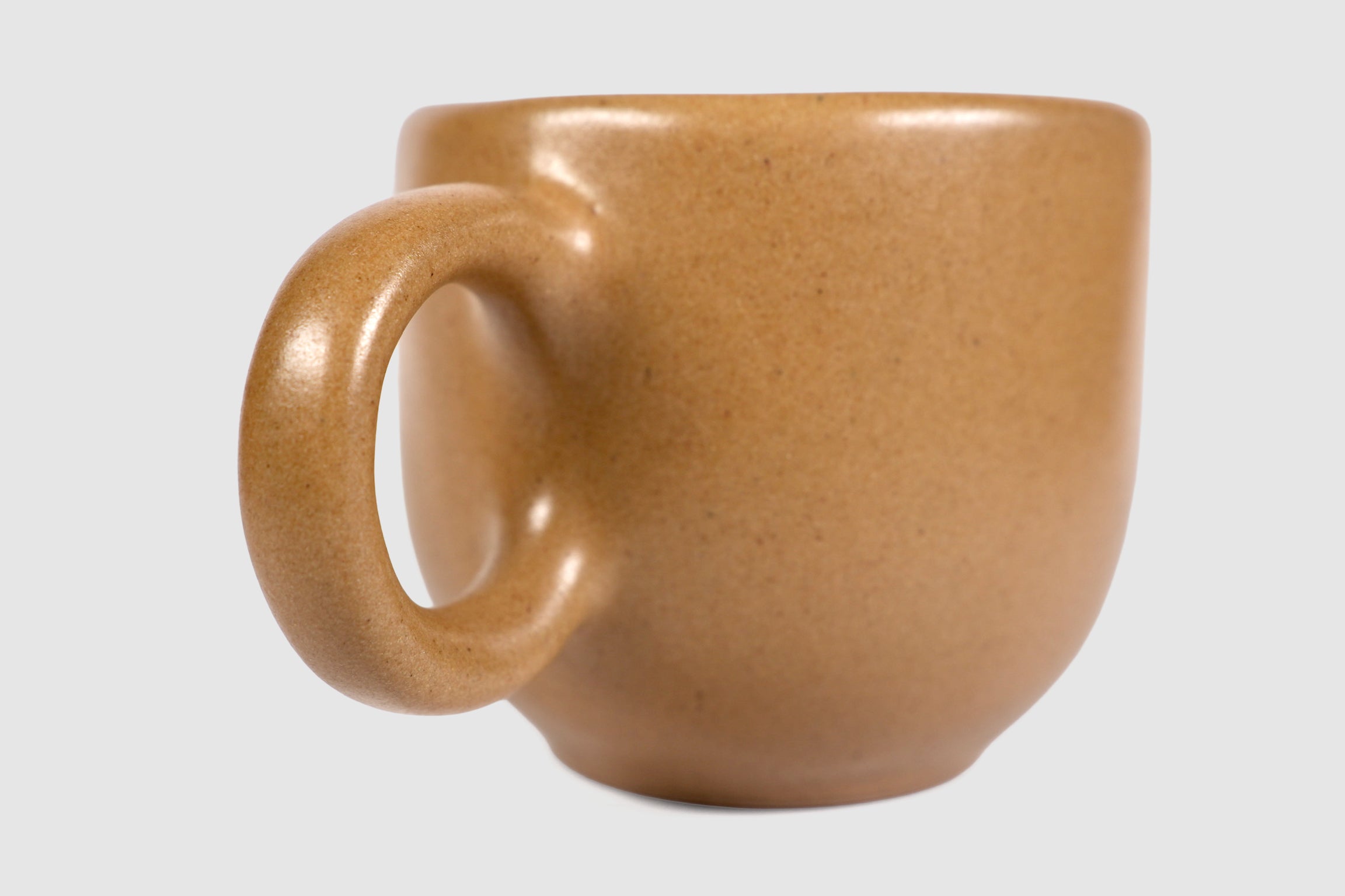 Rounded cappuccino mug with spherical body and circular ring handle in Pardo