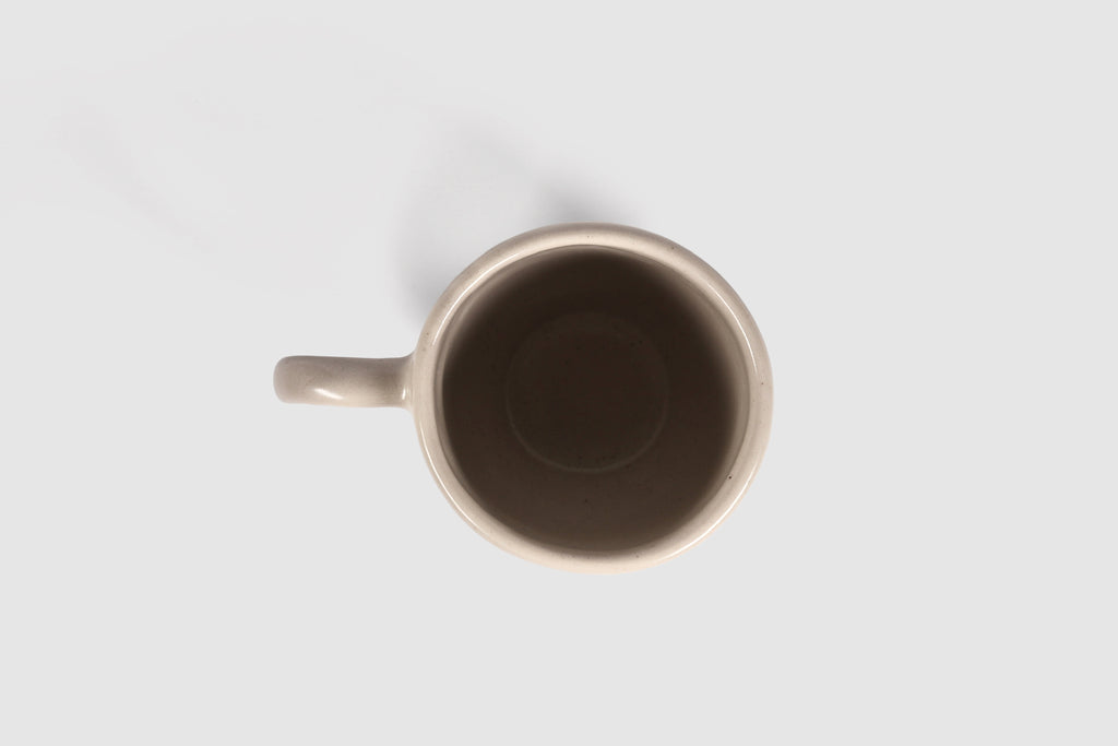 Rounded cappuccino mug with spherical body and circular ring handle in Pardo
