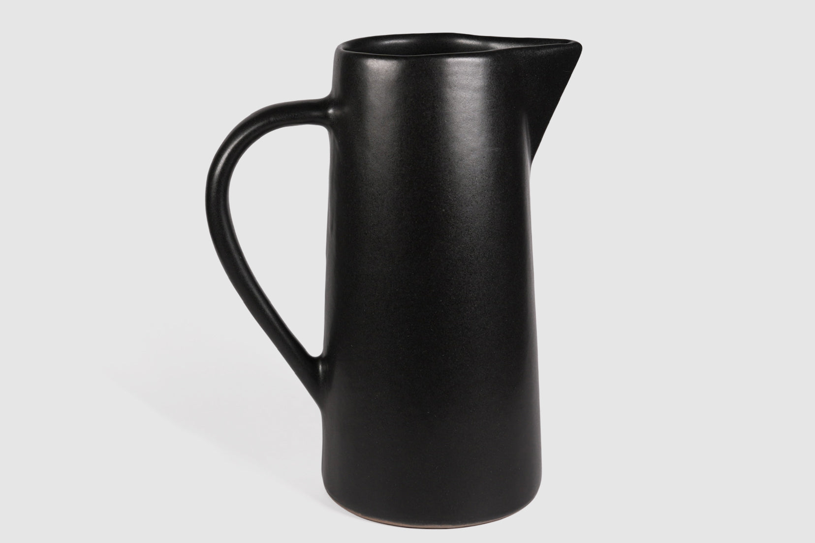 Tall Rojizo ceramic pitcher with tapered body, pouring lip and pulled handle