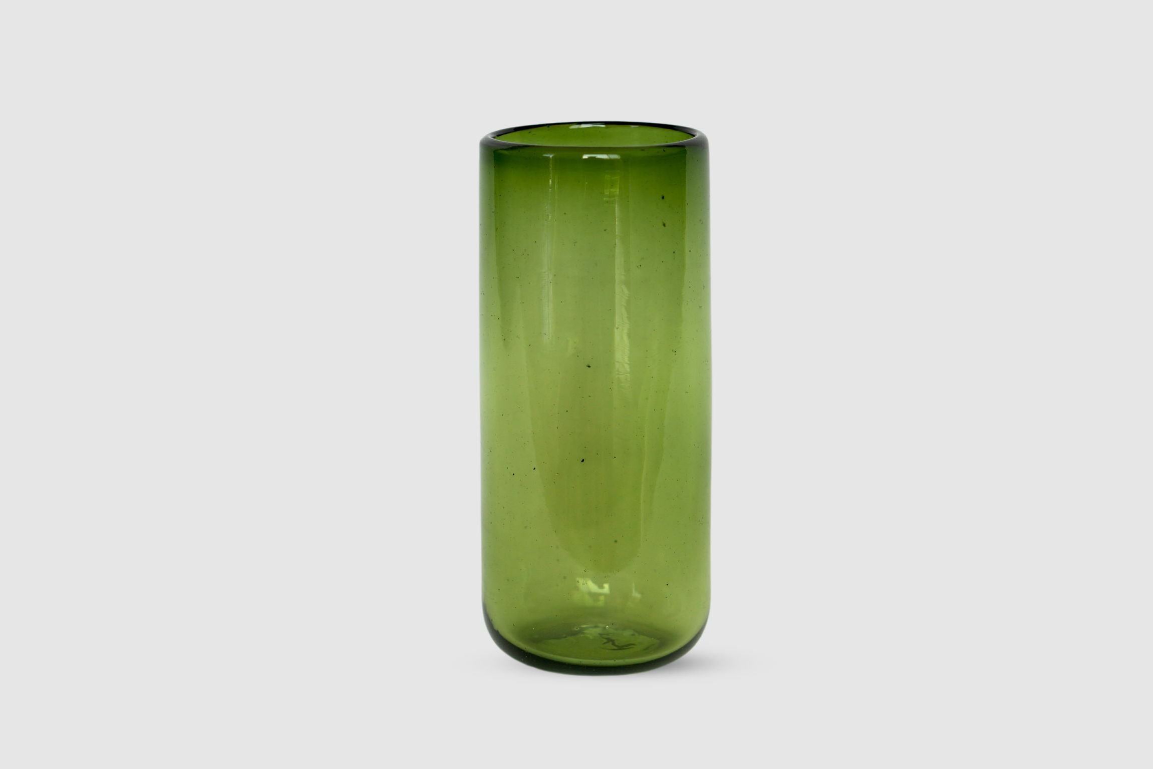 Olive-tinted hand-blown highball glass shown on white background