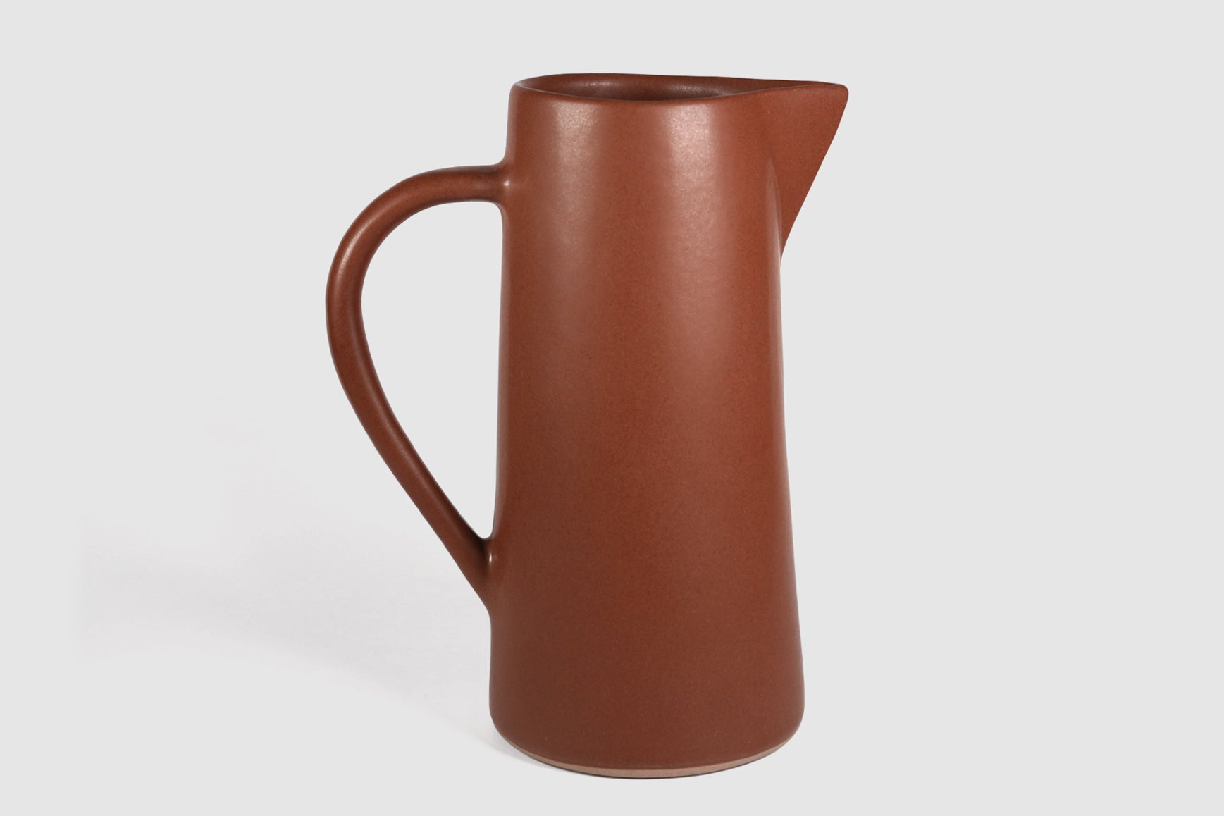 Tall Rojizo ceramic pitcher with tapered body, pouring lip and pulled handle