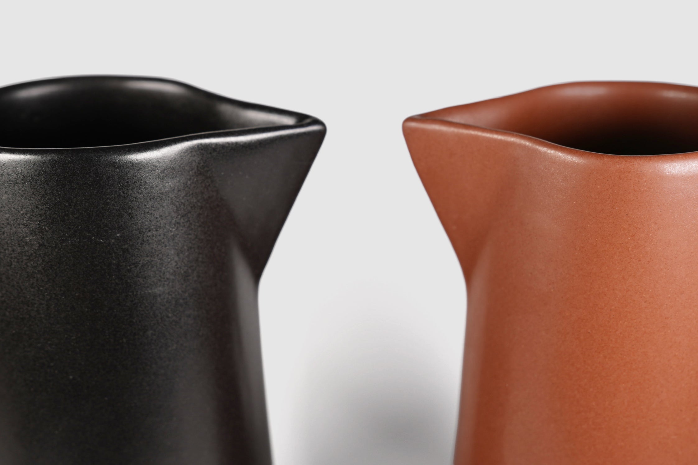 Tall Rojizo ceramic pitcher with tapered body, pouring lip and pulled handle