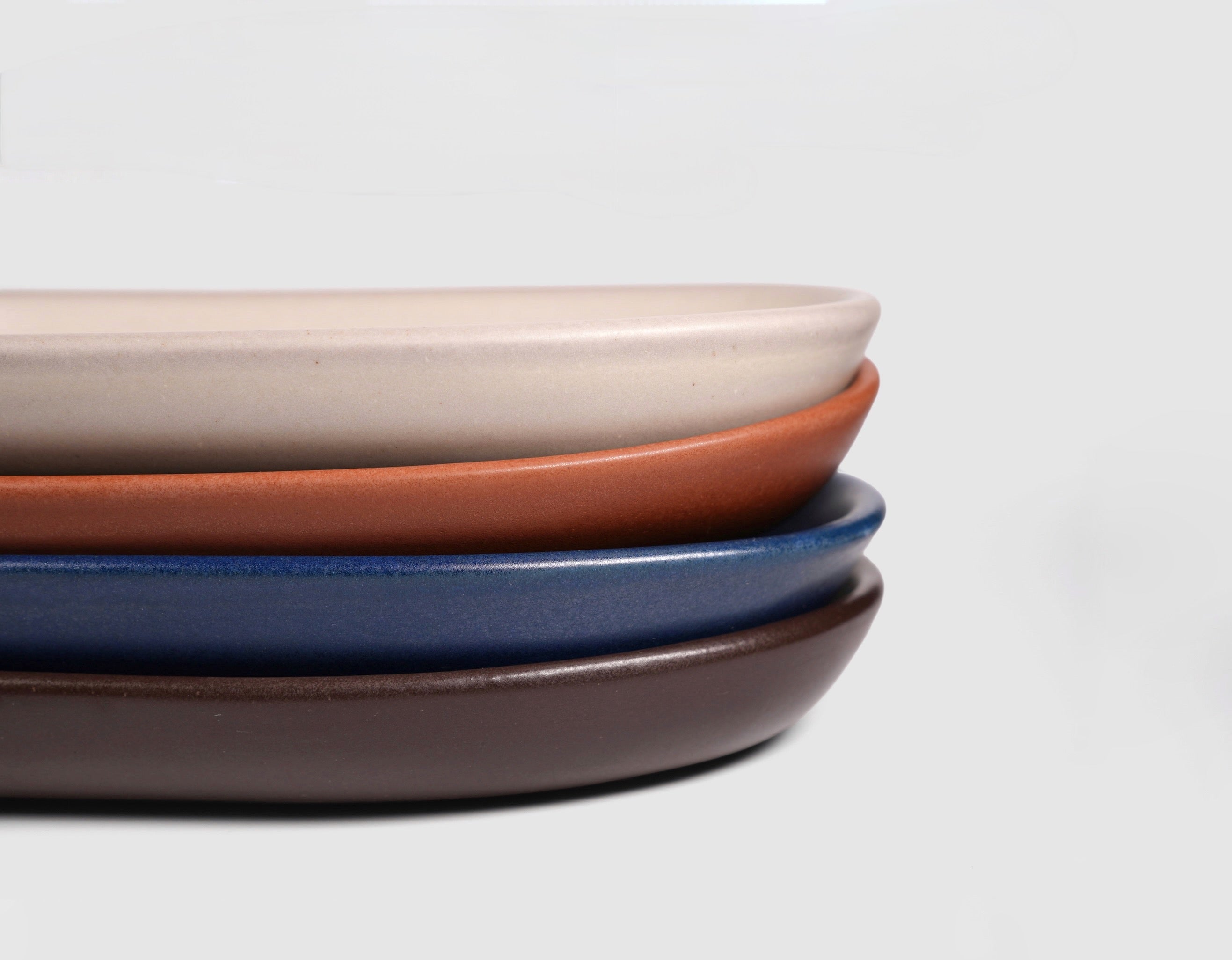 Small Baguette Tray by Humo 1810 – rojizo oval stoneware tray, raised rim, red-clay glaze, 10.25 inch
