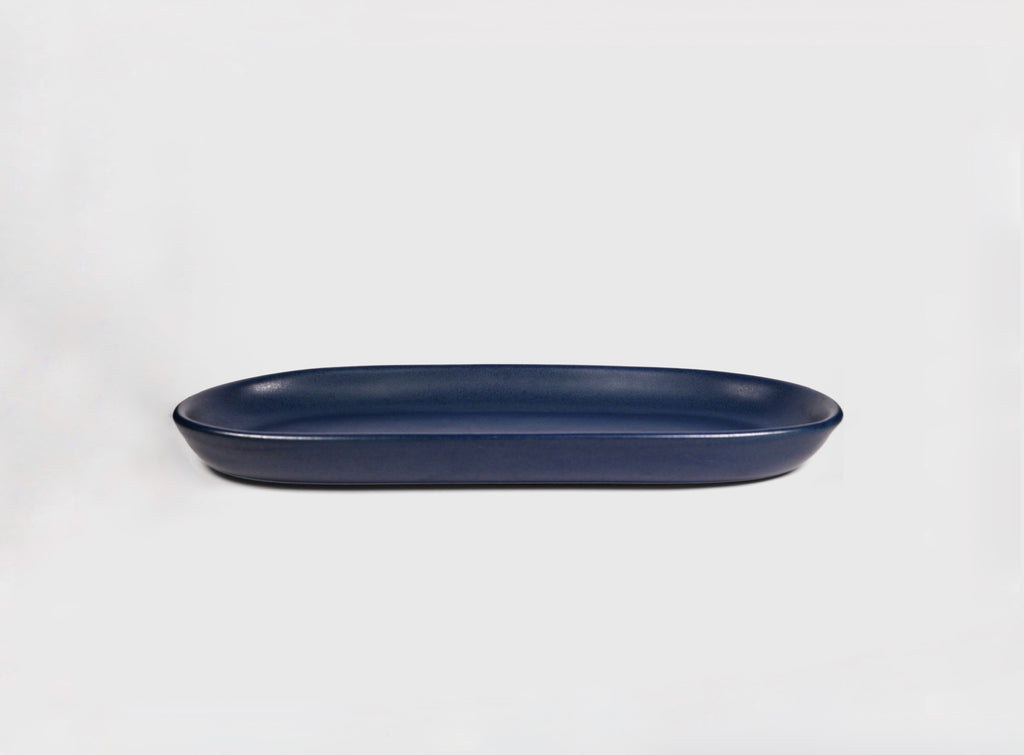 Small Baguette Tray by Humo 1810 – rojizo oval stoneware tray, raised rim, red-clay glaze, 10.25 inch