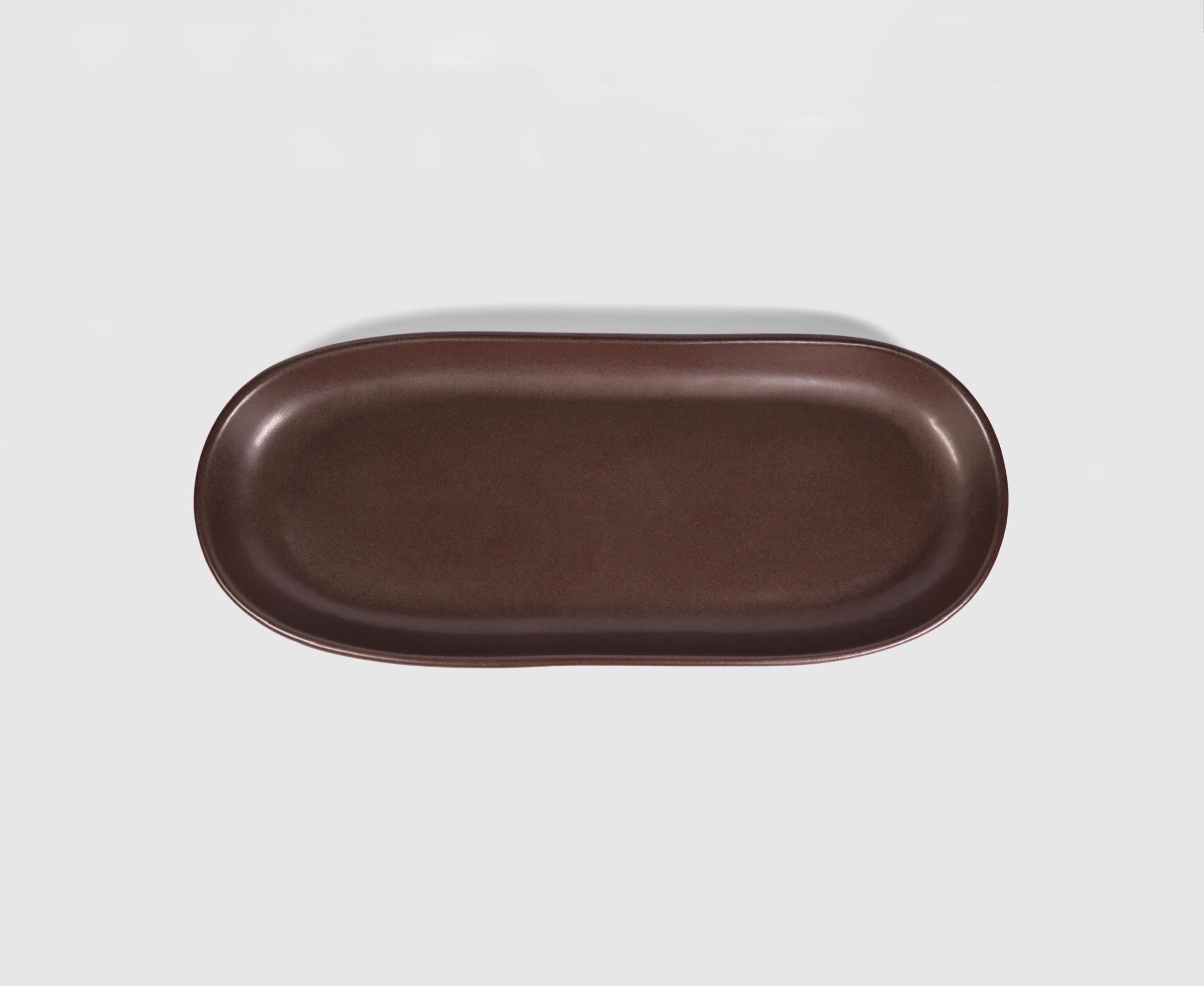 Small Baguette Tray by Humo 1810 – rojizo oval stoneware tray, raised rim, red-clay glaze, 10.25 inch