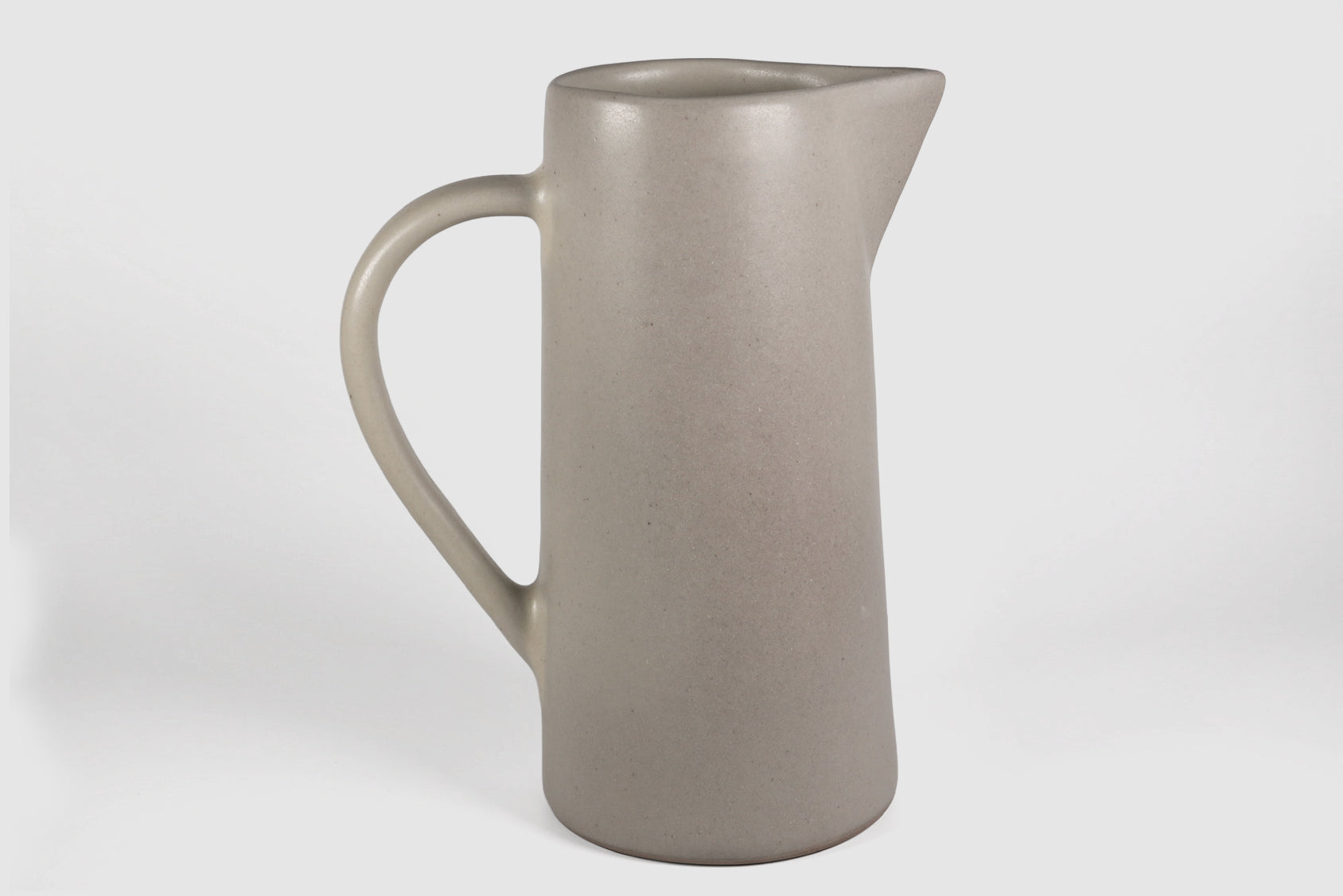 Tall Rojizo ceramic pitcher with tapered body, pouring lip and pulled handle