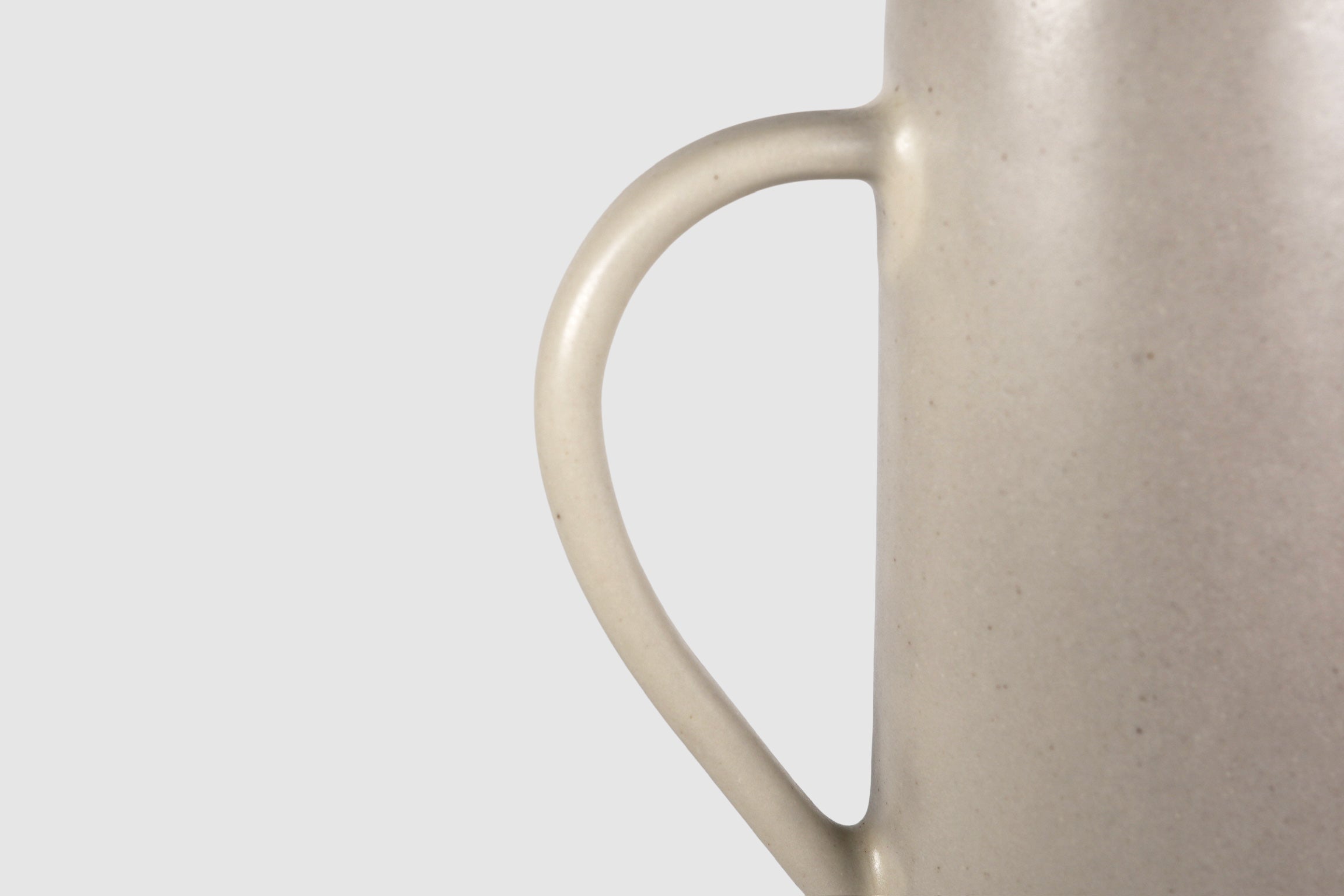 Tall Rojizo ceramic pitcher with tapered body, pouring lip and pulled handle