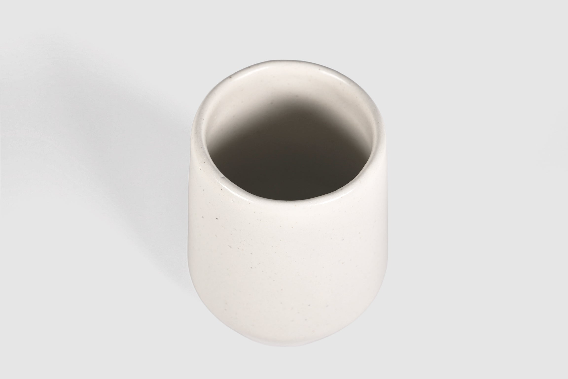 Tall stoneware tumbler with shouldered taper, matte finish.