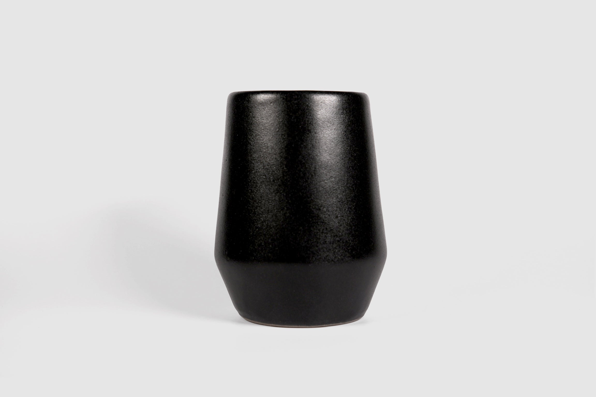 Tall stoneware tumbler with shouldered taper, matte finish.