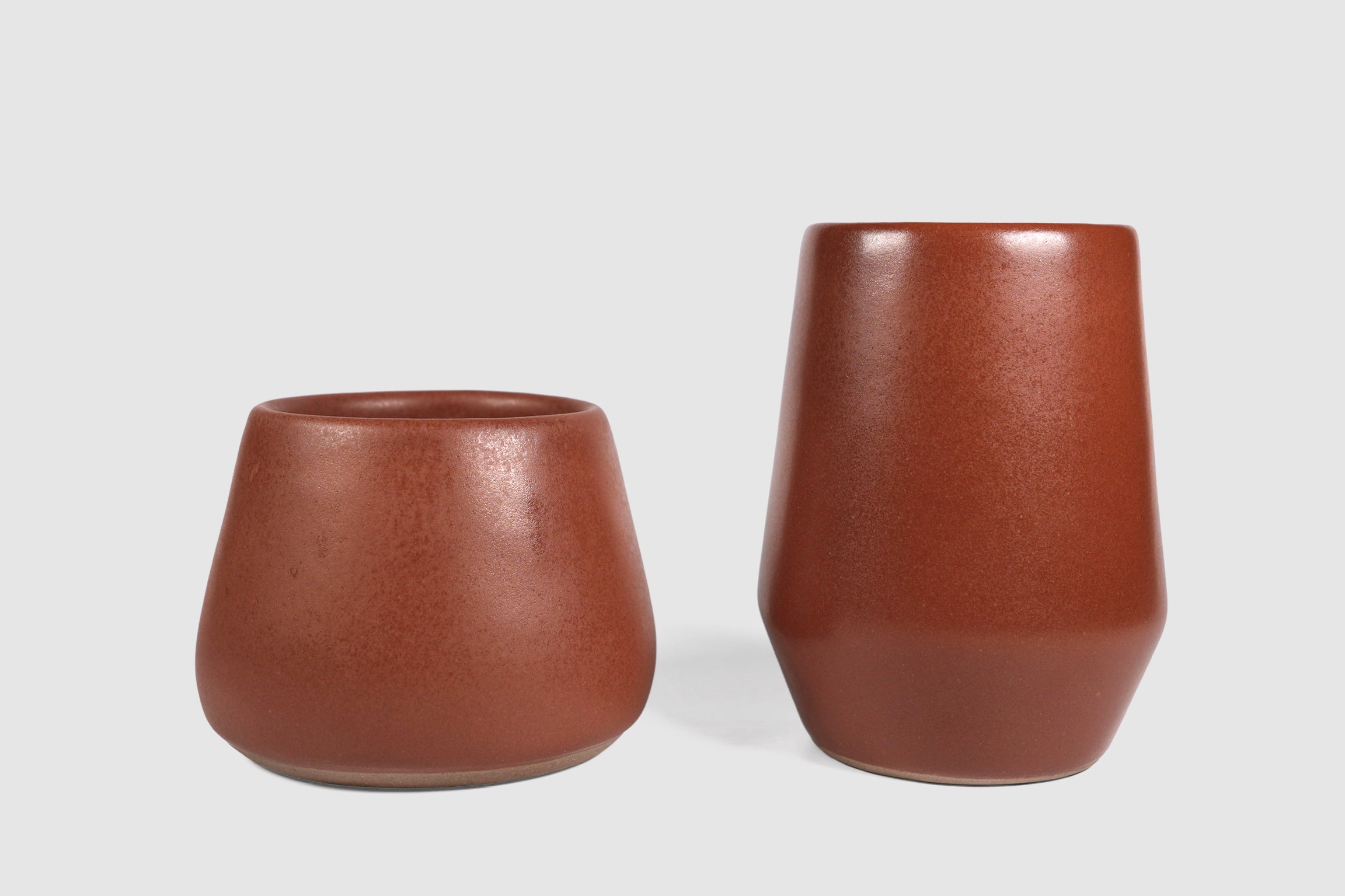 Tall stoneware tumbler with shouldered taper, matte finish.