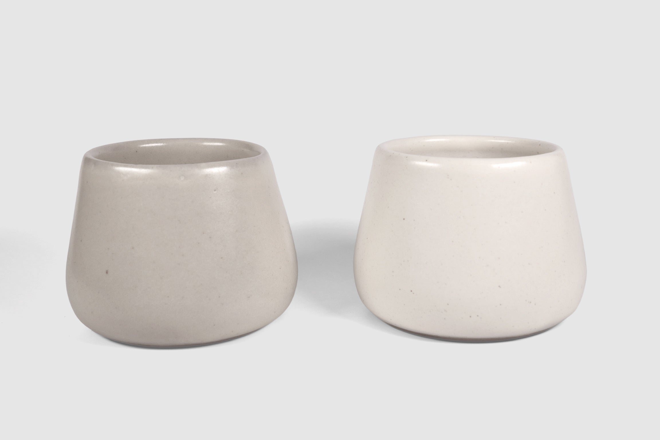Squat stoneware tumbler, low belly, softly rolled matte rim.