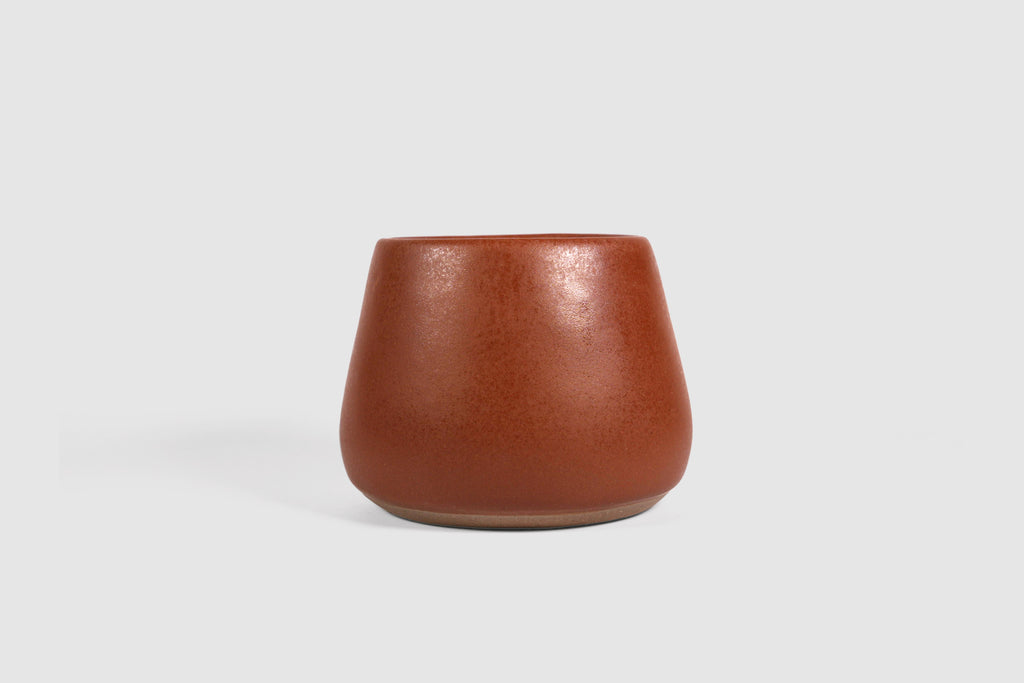 Squat stoneware tumbler, low belly, softly rolled matte rim.