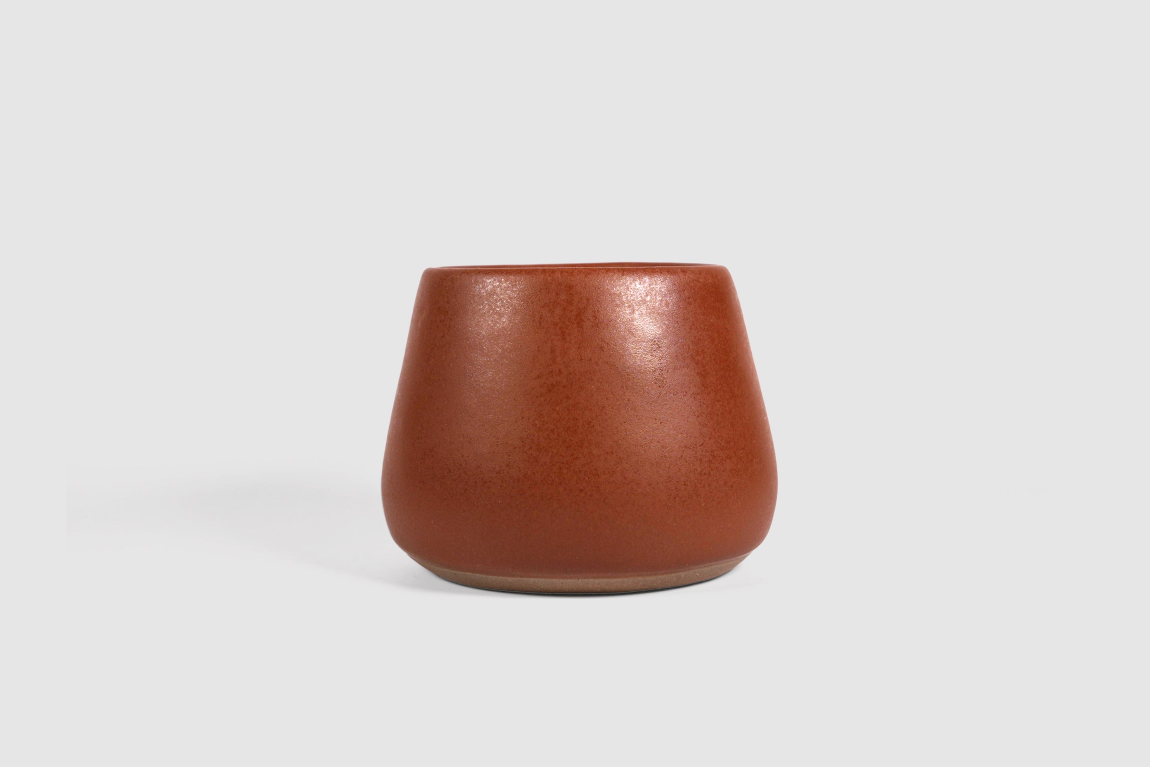Squat stoneware tumbler, low belly, softly rolled matte rim.