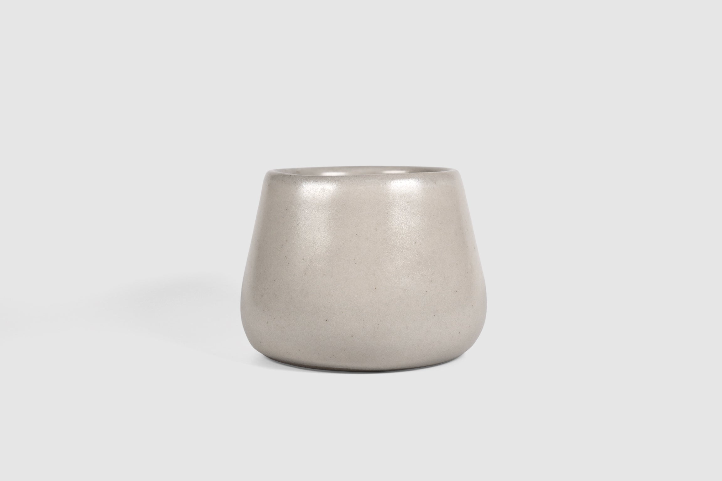 Squat stoneware tumbler, low belly, softly rolled matte rim.